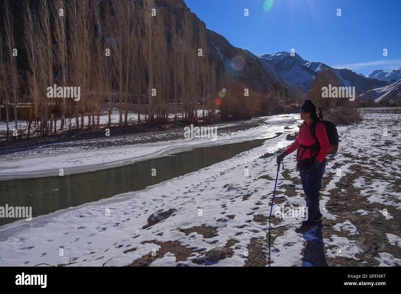 Lady enjoying the view of the mountain during the winter trek in Ladakh Stock Photo