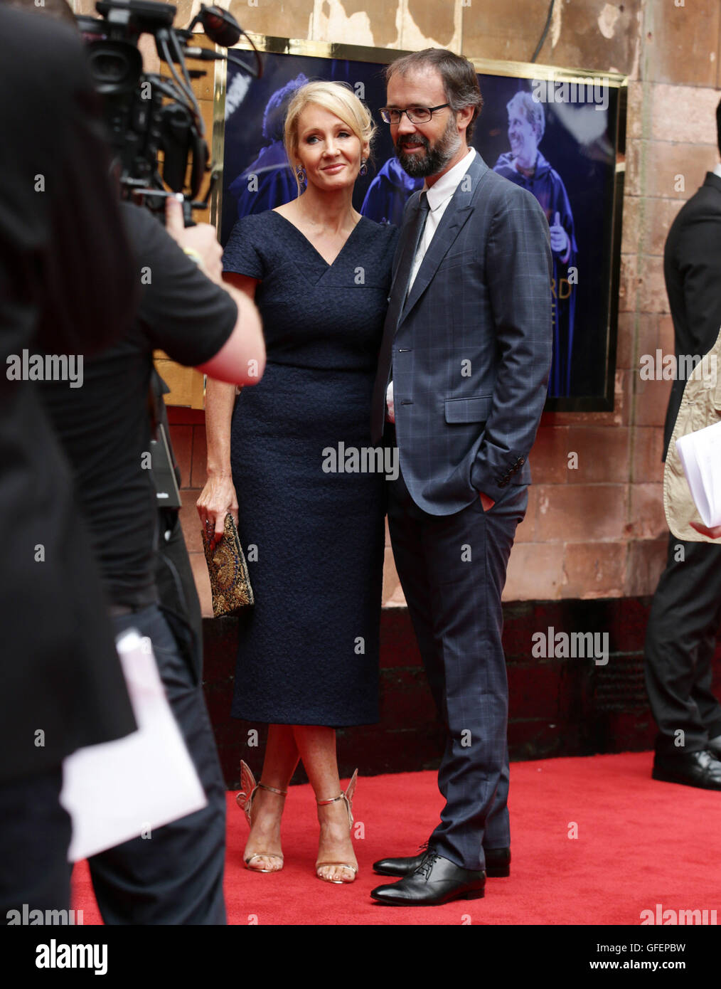 JK Rowling and her husband Neil Murray arrive for the opening gala performance of Harry Potter and The Cursed Child, at the Palace Theatre in London. Stock Photo