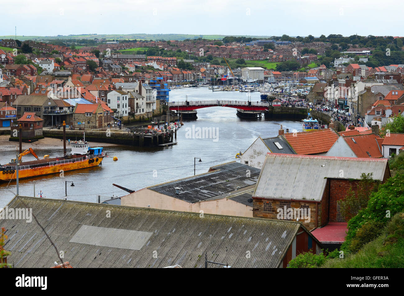 A view of Whitby Pier and harbour looking across rooftops in The North ...