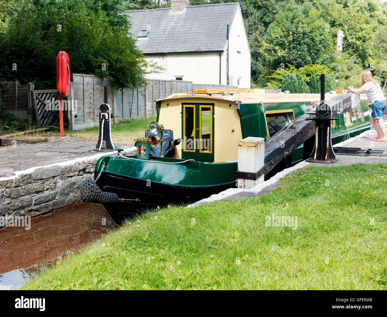 Narrow boat leaving Brynich Lock near Brecon on the Monmouth and Brecon Canal heading for Brecon Basin. Stock Photo