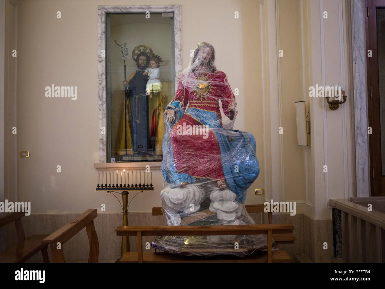 A stature of Jesus is wrapped in cling film at Mother Church of 'St. George the Martyr' in Locorotondo, Puglia, Italy Stock Photo