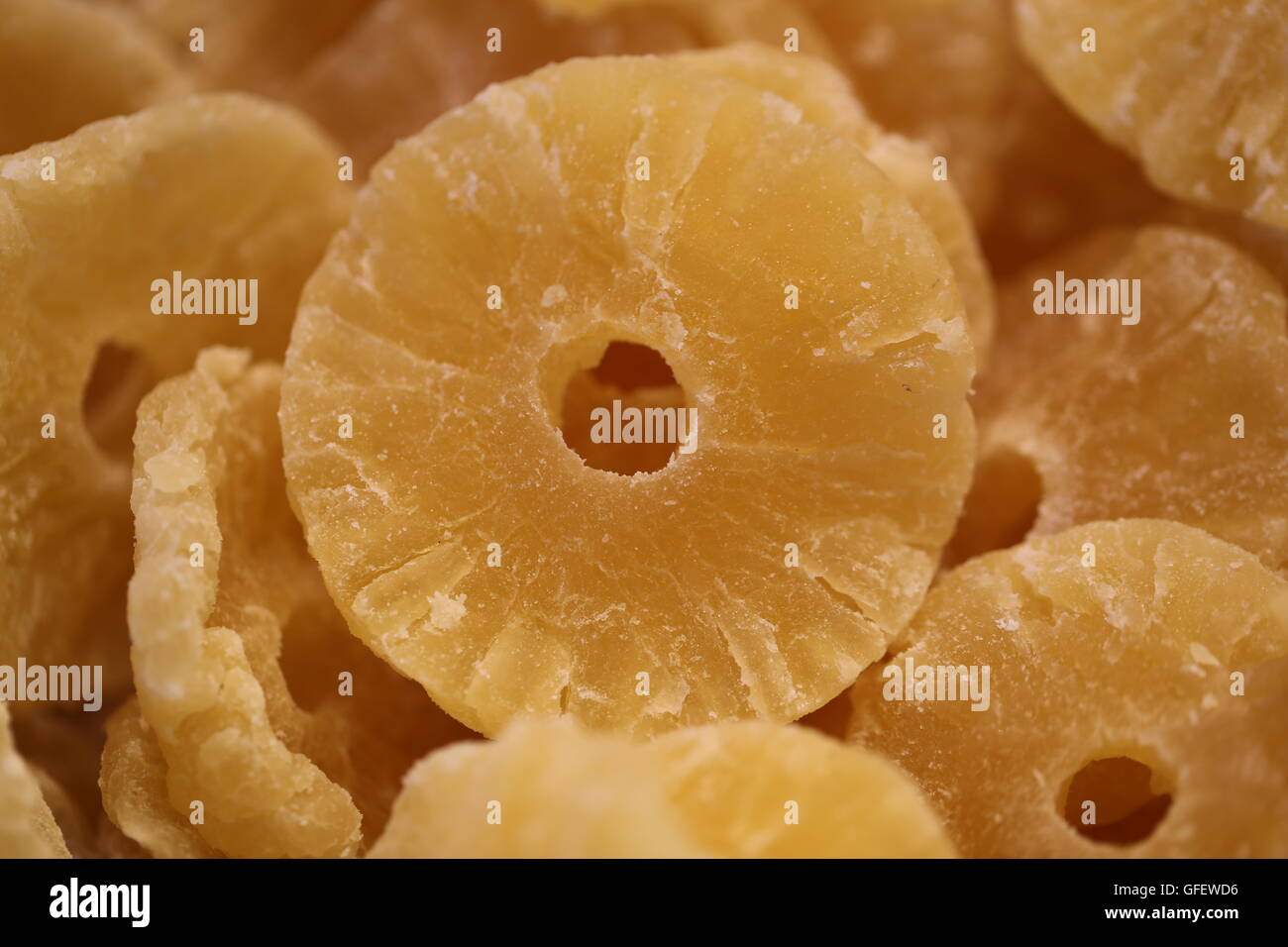 Pineapple Slices, Pineapple Rings. Pile of candied pineapple slices, dehydrated pineapple rings, crystallized Pineapple, close up. Stock Photo