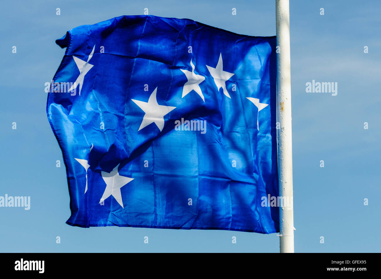 Belfast, Northern Ireland. 20 Apr 2014 - A 'Starry Plough' flag flies over the grave of a former member of the Irish National Liberation Army (INLA) Stock Photo