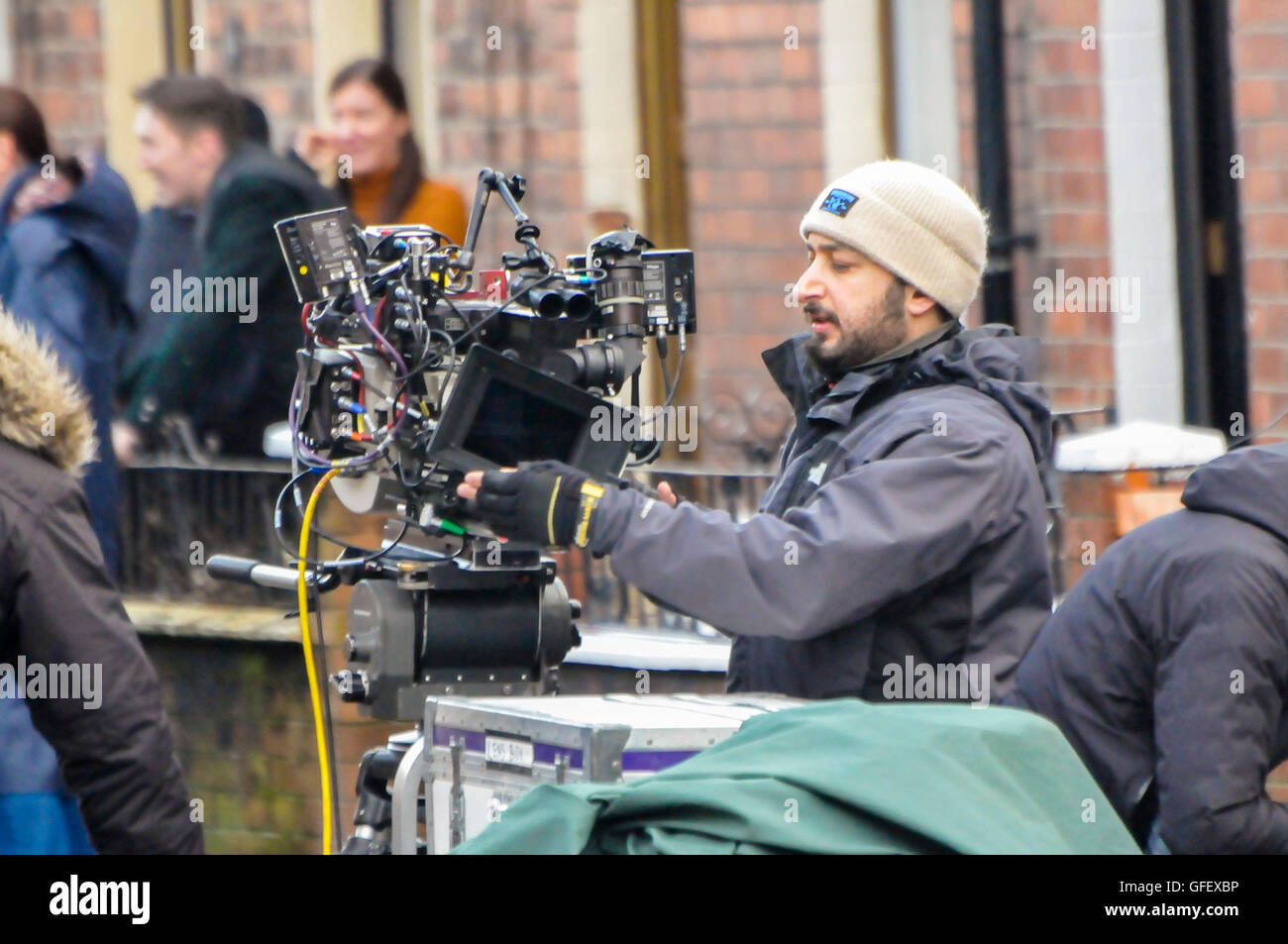 Belfast, Northern Ireland. 18 Dec 2014 - A cameraman adjusts the matte-box of a movie quality camera Stock Photo