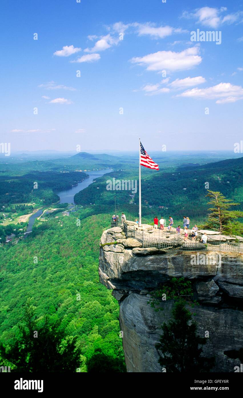 Union US flag on Chimney Rock overlook viewpoint landmark in Chimney Rock Park above Lake Lure North Carolina USA Stock Photo