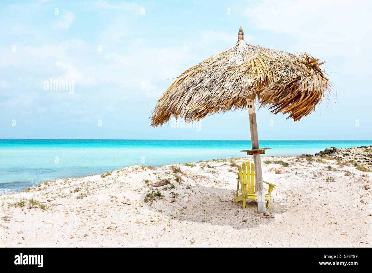 Grass umbrella at the beach on Aruba island in the Caribbean Stock