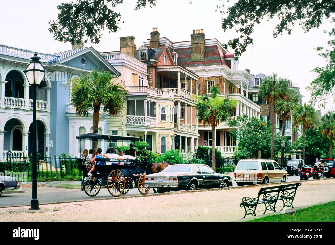 Charleston, South Carolina, USA. Tourist buggy passes old historic traditional town houses villas on the South Battery Stock Photo