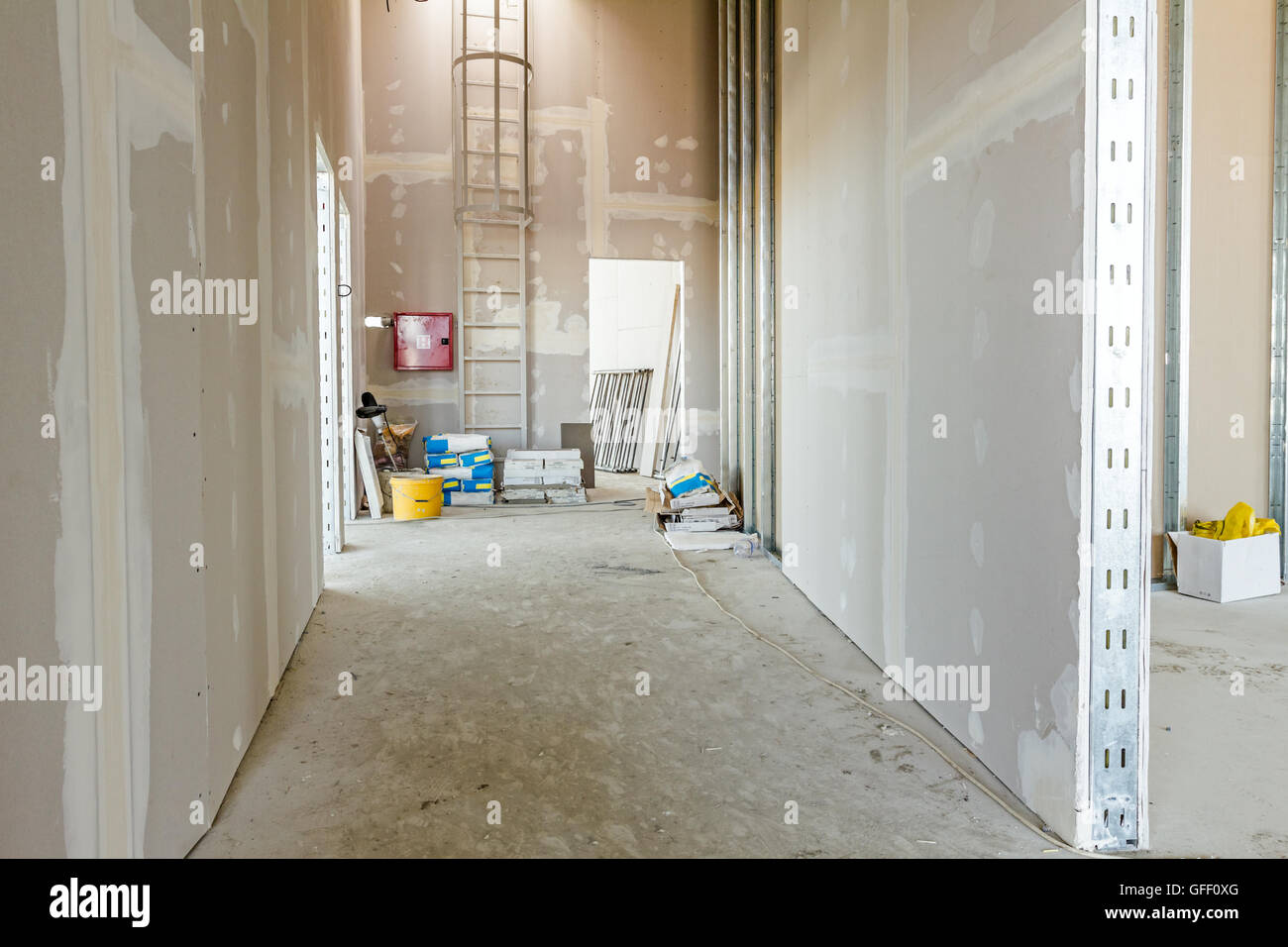 View through corridor of gypsum, plasterboard walls under construction. Stock Photo