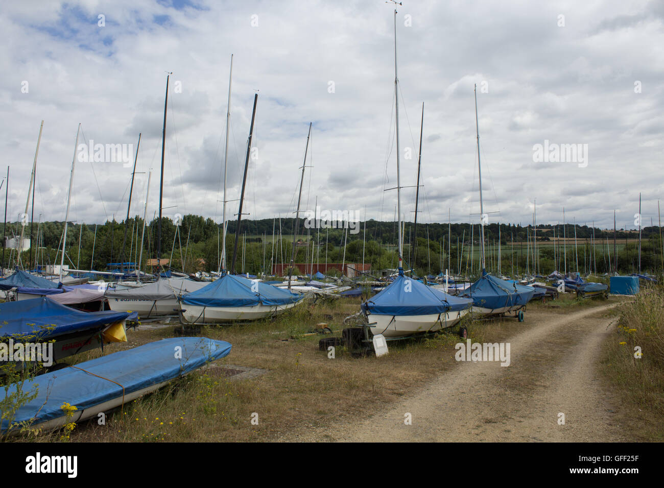 Sail boats sit on trailers outside Oxford Sailing Club at Farmoor Reservoir, Oxfordshire, UK Stock Photo