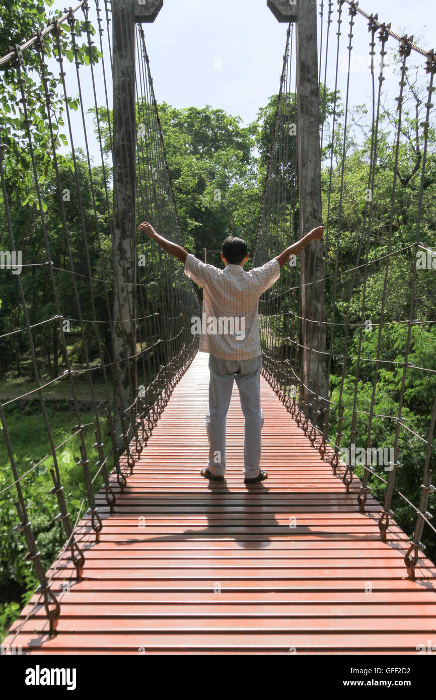 rope bridge or suspension bridge in forest at Khao Kradong Forest Park in Buriram Province,THAILAND. Stock Photo