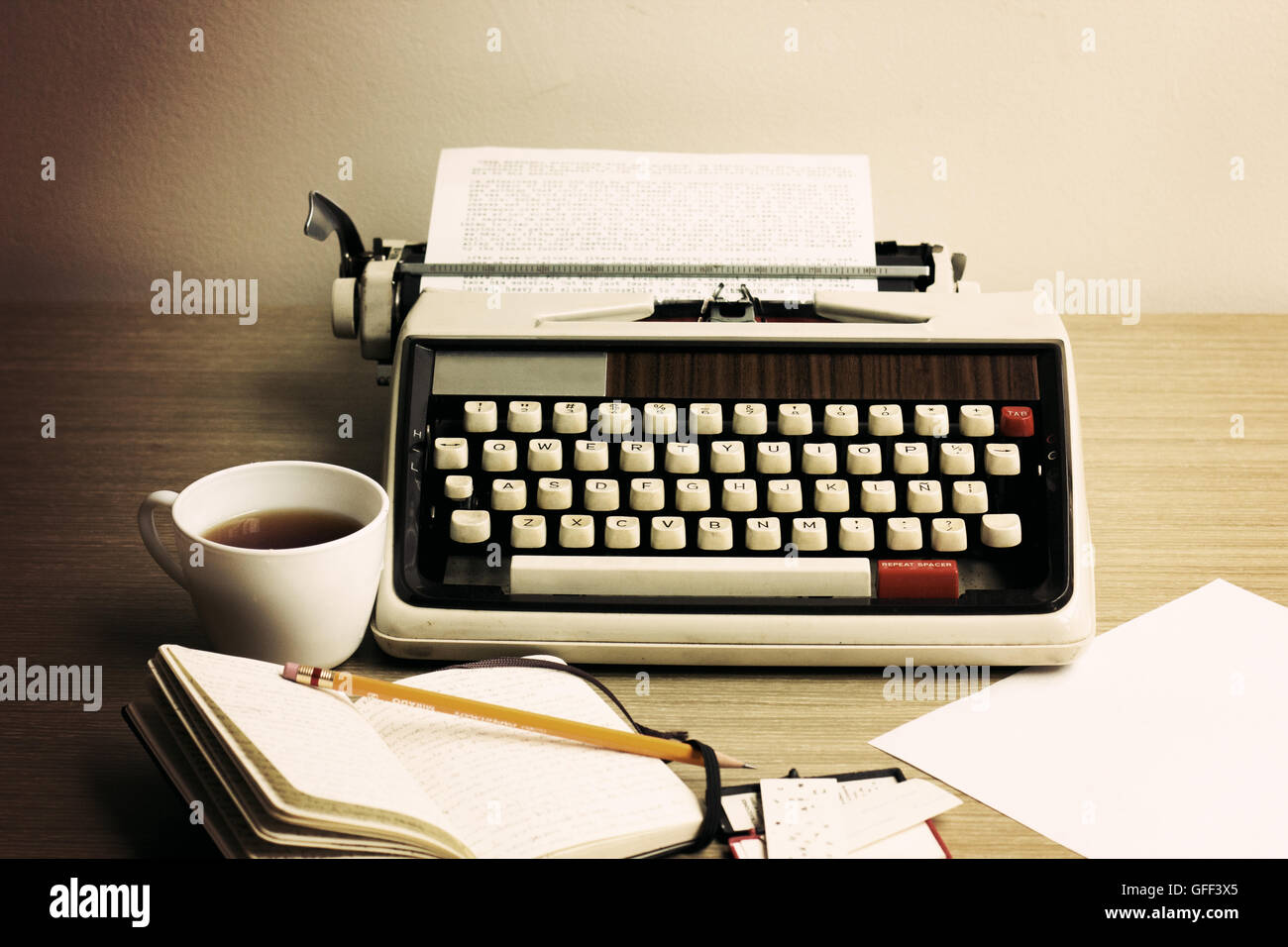 Vintage typewriter, cup of coffee, notebook and pencil Stock Photo - Alamy