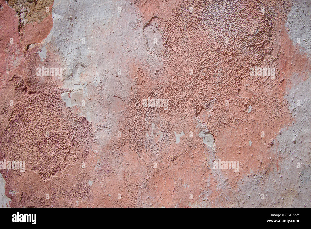 peace of wall with damaged pink plaster as a background in pastel colors Stock Photo