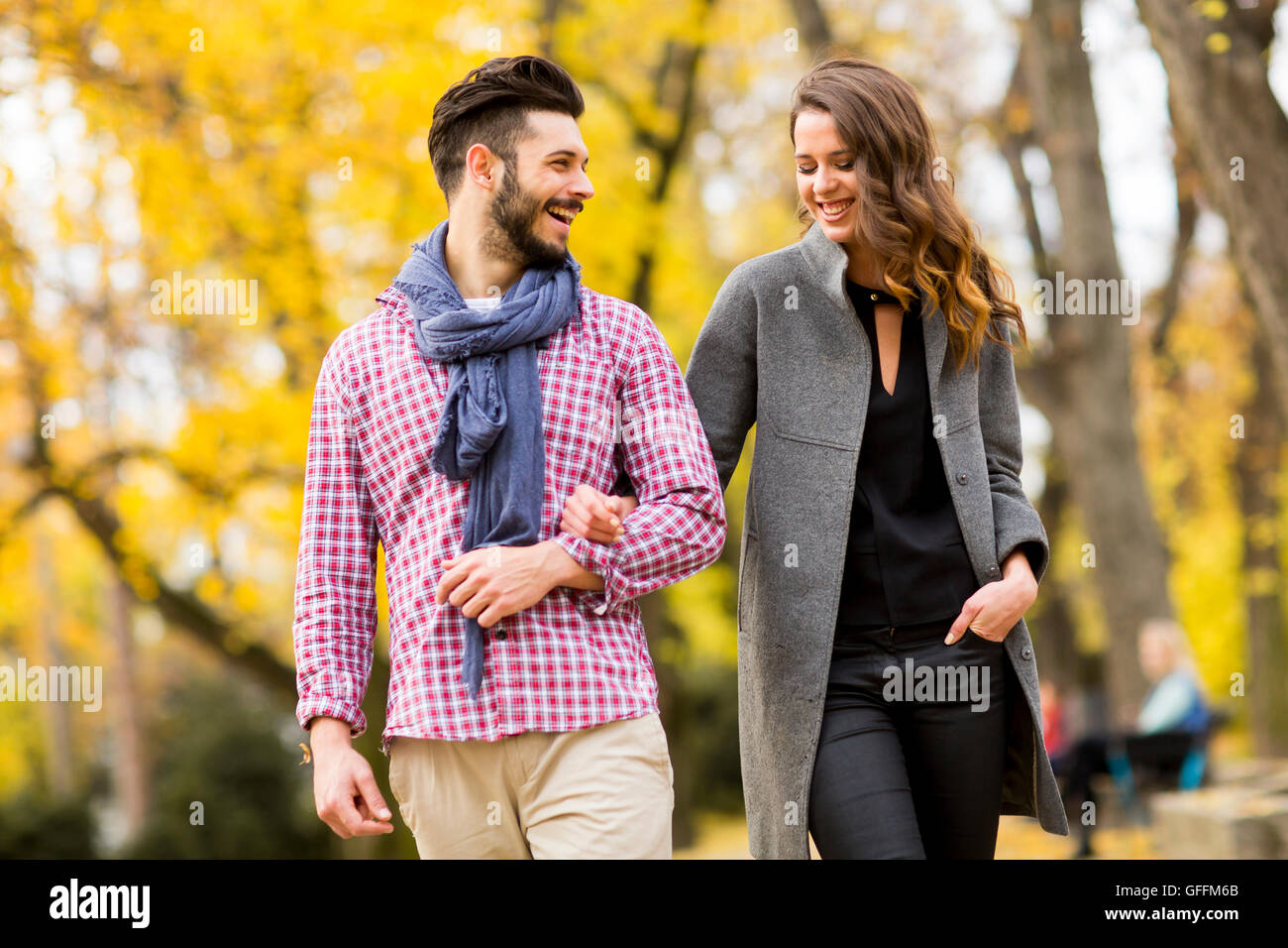Young loving couple having a walk in the autumn park Stock Photo - Alamy