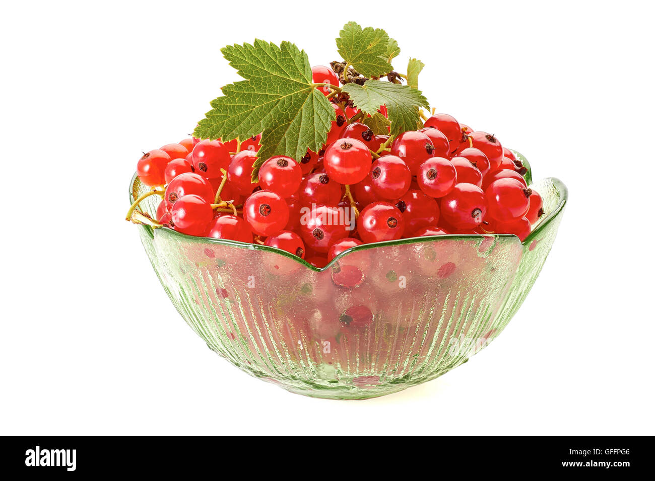 Red currant berries in green glass bowl on white Stock Photo
