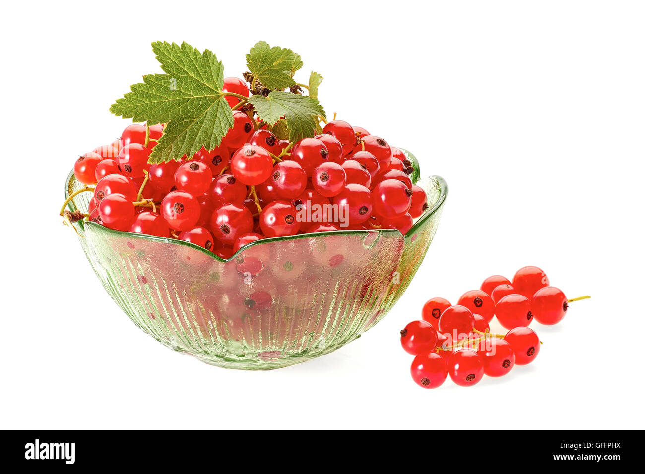 Red currant berries in green glass bowl on white Stock Photo