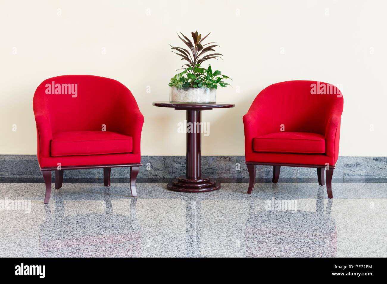Modern red armchairs and table in a foyer Stock Photo