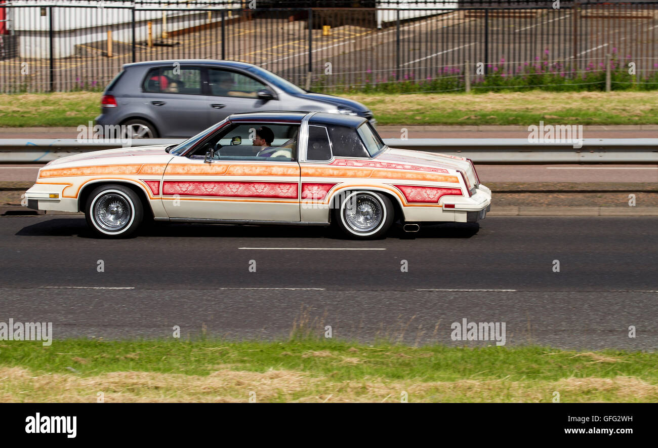 A modified American style Cadillac kit car travelling along the Kingsway Dual Carriageway in Dundee, UK Stock Photo