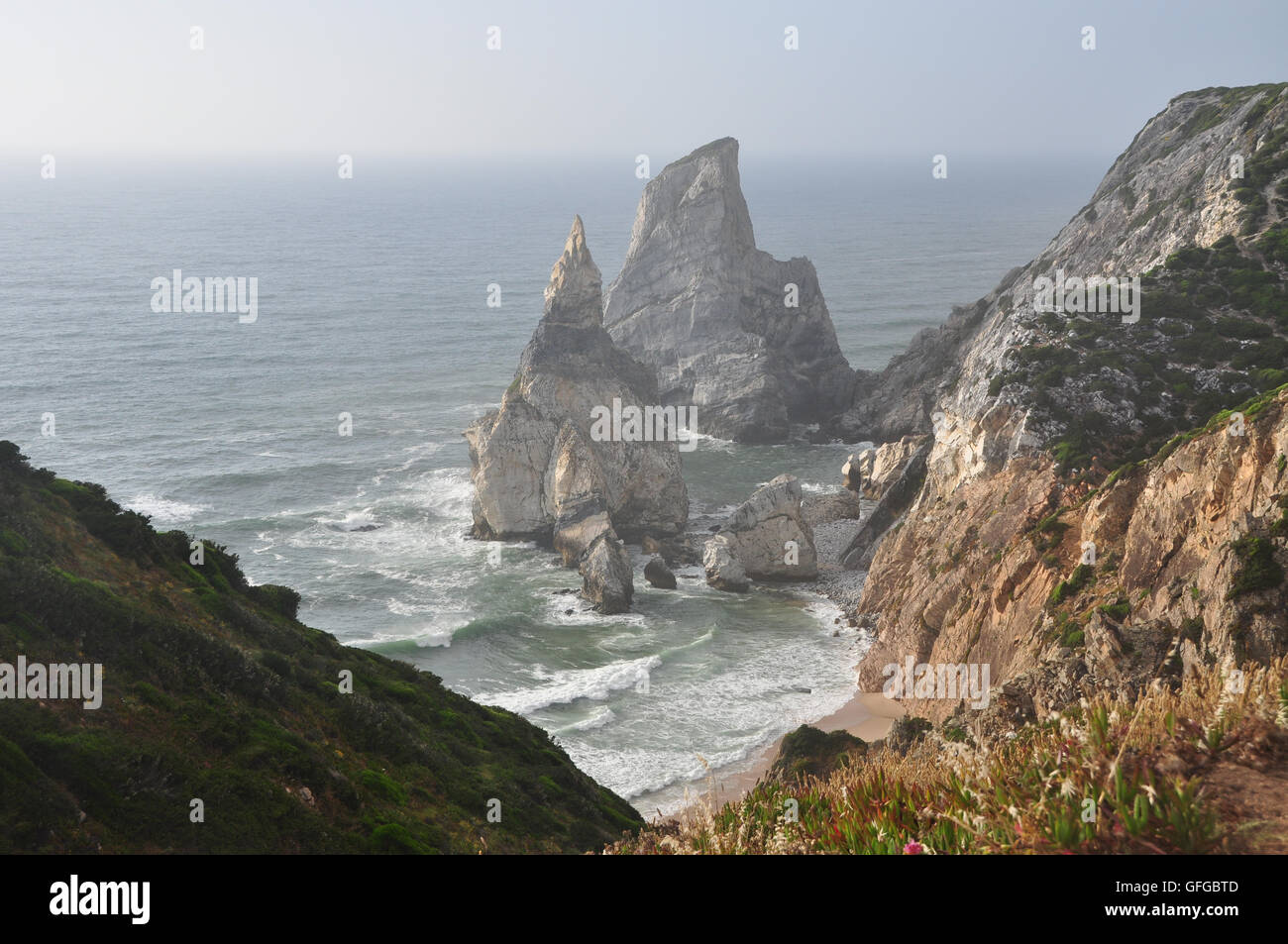 Beautiful, majestic, rocky structures create impressive, incredible view across from rocky cliff at Praia da Ursa in Portugal Stock Photo