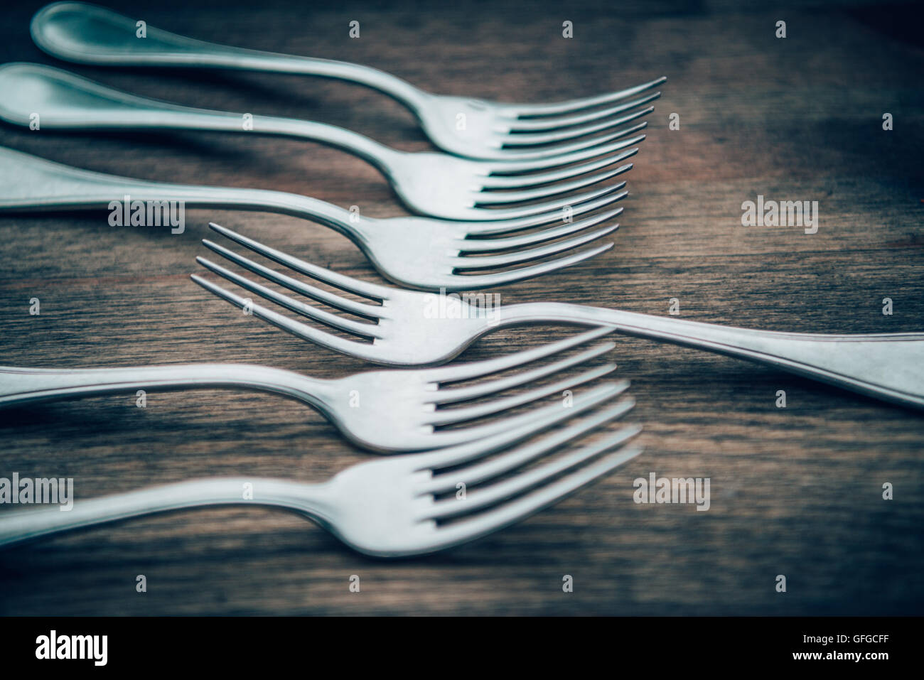 Forks arranged with one facing the opposite direction. Stock Photo