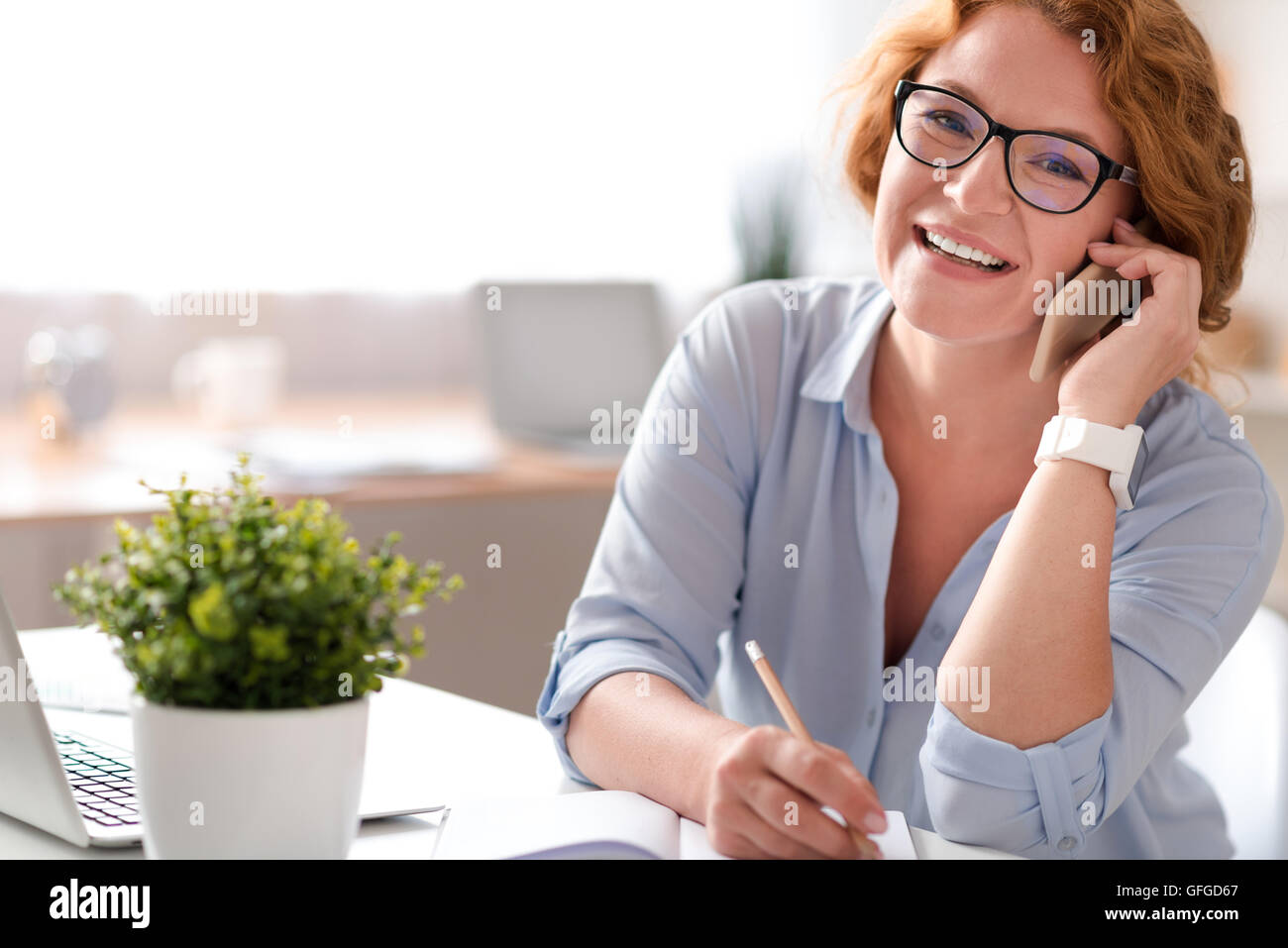 Joyful woman talking on cell phone Stock Photo - Alamy