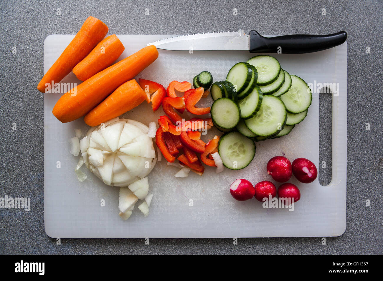 Salad vegetables on a chopping board. Stock Photo