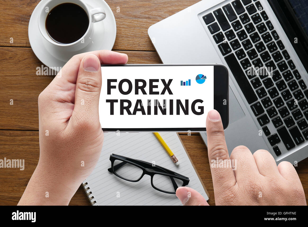 FOREX TRAINING message on hand holding to touch a phone, top view ...