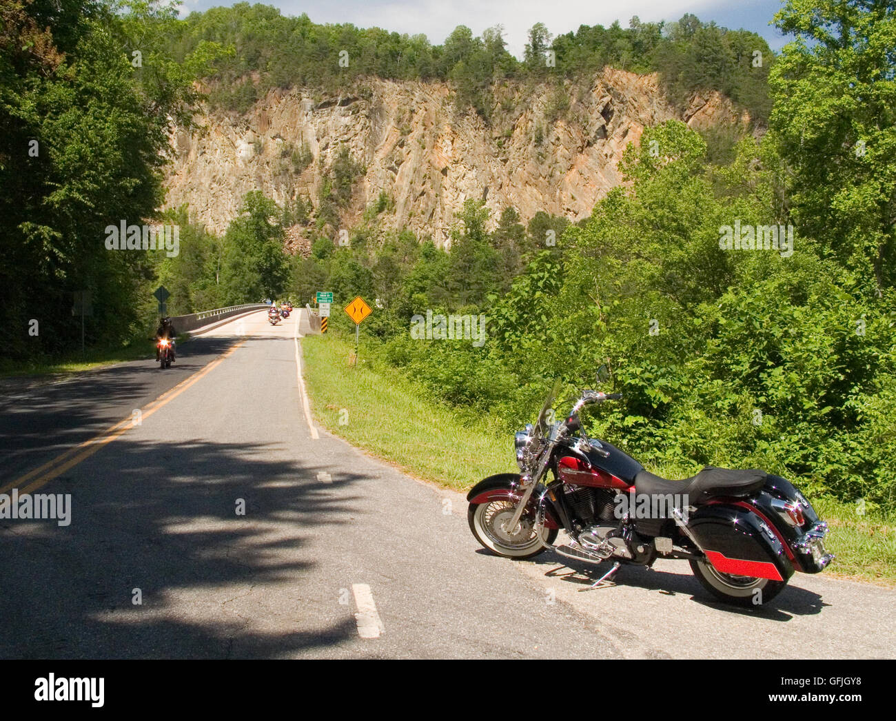A motorcycle is parked on SR28, which runs through three states; Georgia, North Carolina, and Tennessee. Stock Photo