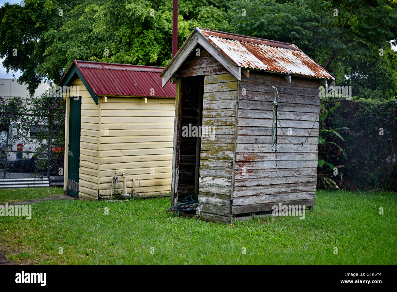 his and hers outside toilets known as dunnies or thundeboxes in garden of business in murwillumbah, since demolished Stock Photo