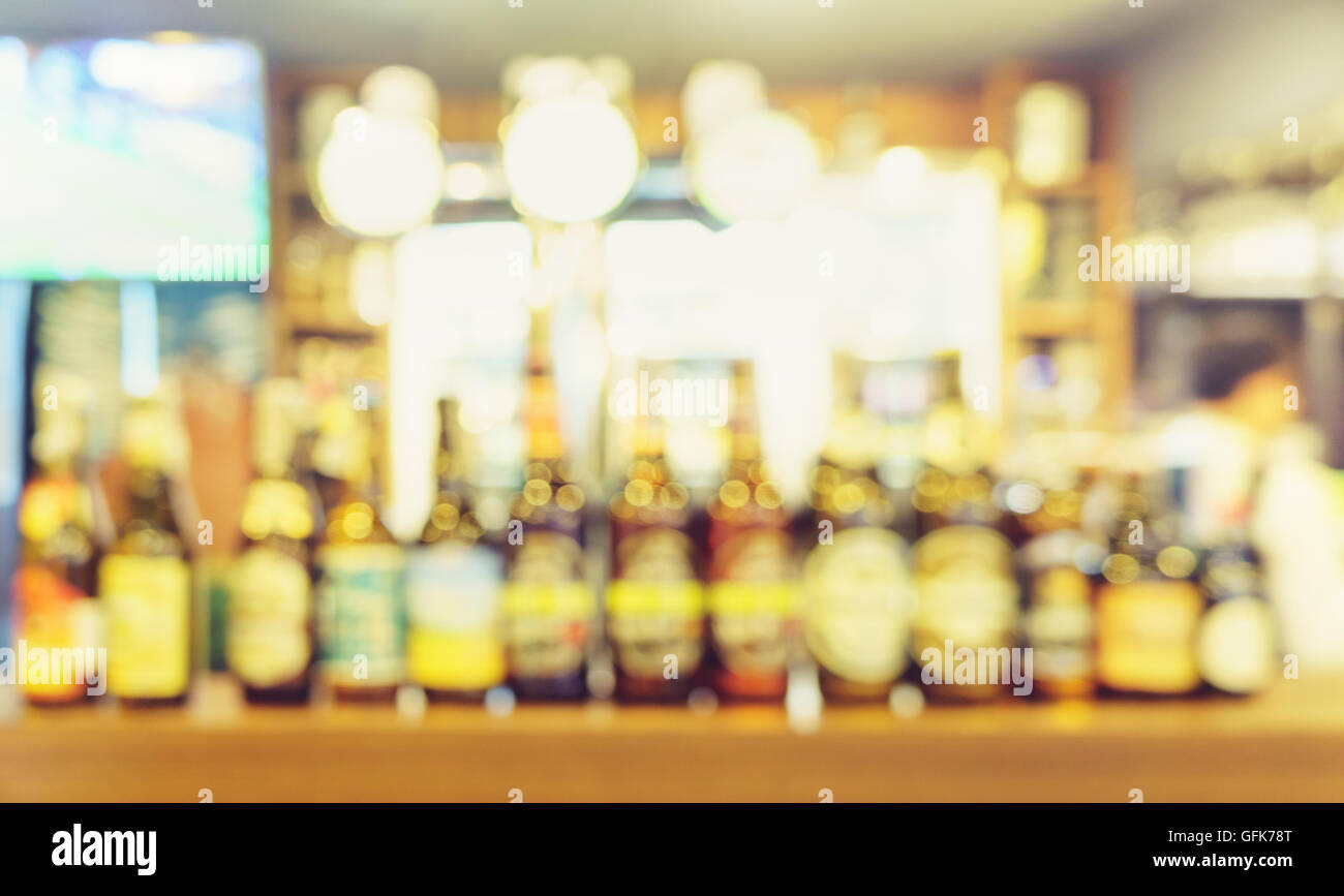 Blur pub bar with beer bottles background Stock Photo