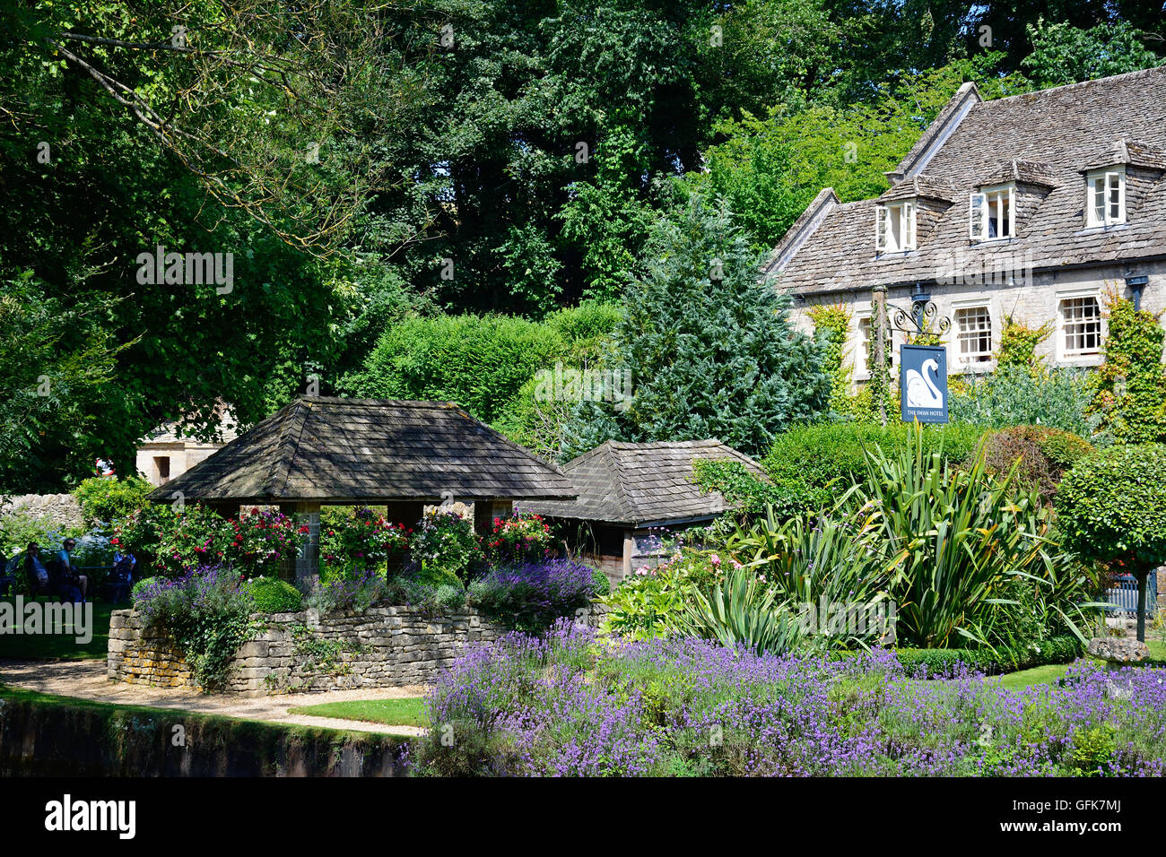 View across the trout farm garden towards The Swan Hotel, Bibury, Cotswolds, Gloucestershire, England, UK, Western Europe. Stock Photo