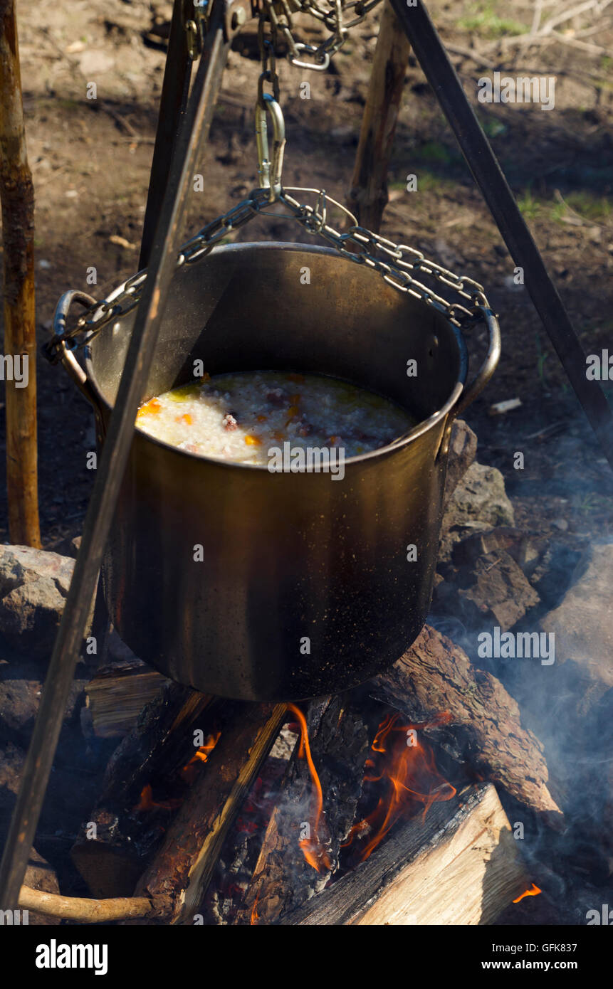Cooking at the wood over campfire Stock Photo - Alamy