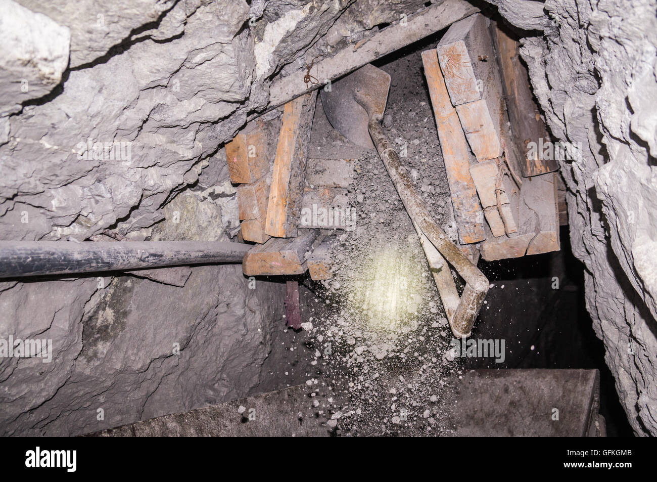 Shovel scratching minerals out of mine shaft. Mining in medieval conditions is performed in this