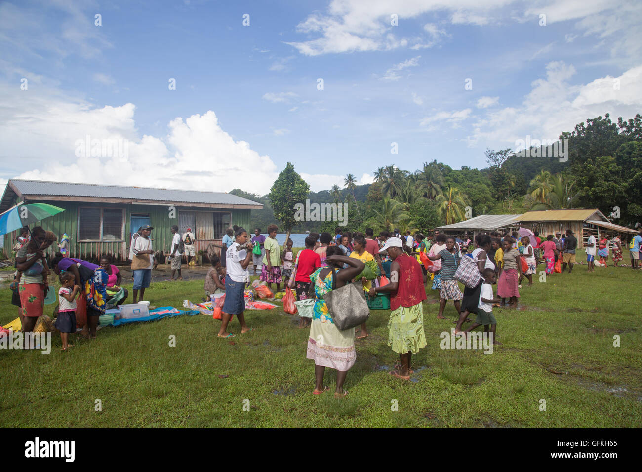 Batuna, Solomon Islands - May 28, 2015: People buying and selling food at the local market in the village of Batuna. Stock Photo