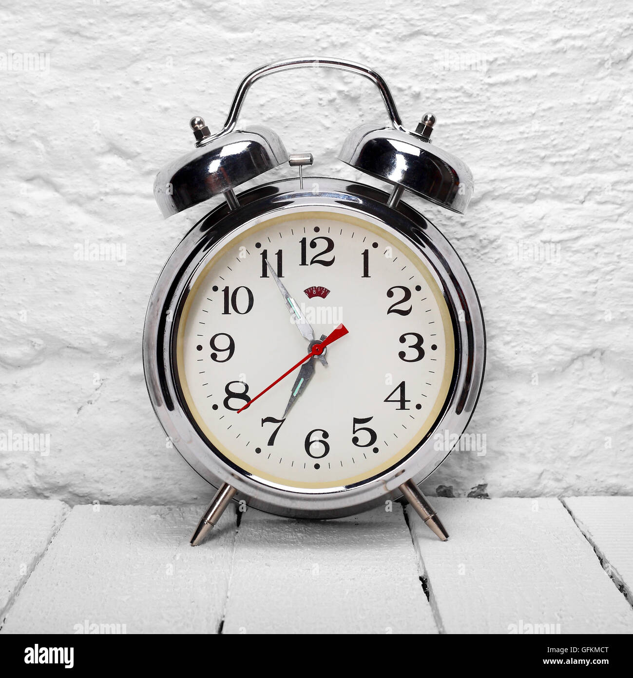 Vintage Alarm Clock - Old retro alarm clock on a white wooden table and ...
