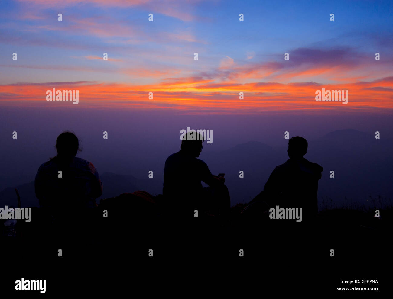 Trekkers watching the sunset from top of Kodachadri Hills (Karnataka, India) Stock Photo