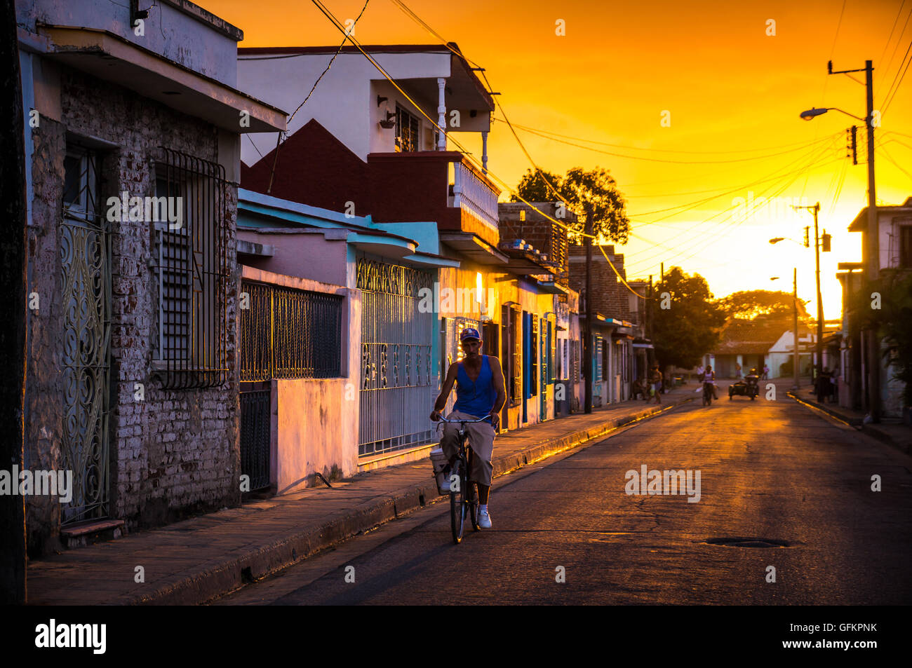 Camaguey, Cuba on January 2, 2016: Cuban man riding his bicycle through a street in the historic Caribbean city center of Camagu Stock Photo