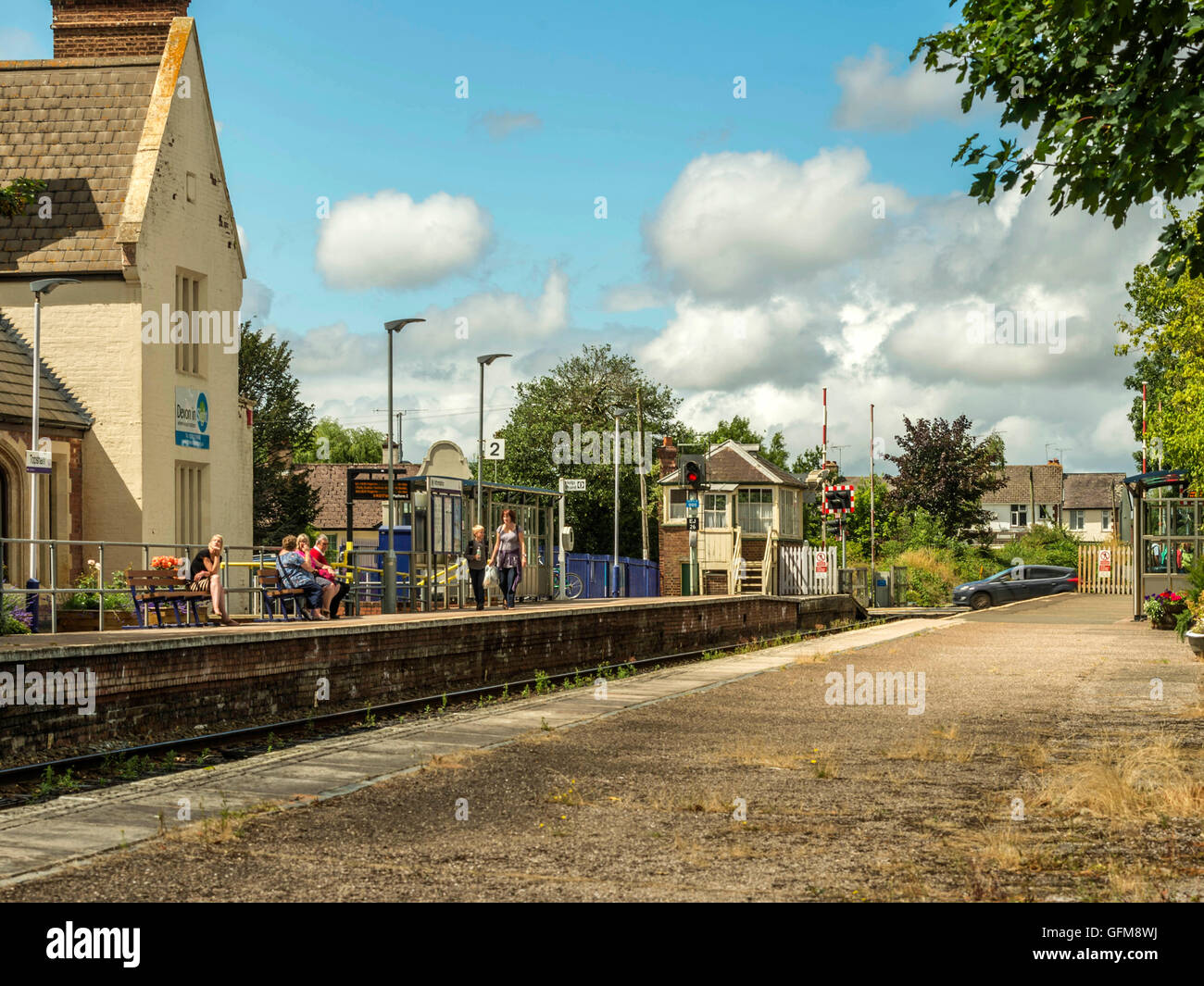 Passengers wait for a First Great Western Train to arrive at pretty Topsham station bound for Exeter along the Avocet line. Stock Photo