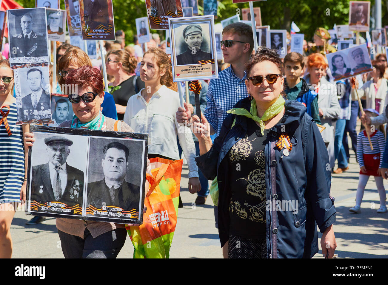 Marchers carrying photographs of dead relatives and soldiers in 9th May Victory Day parade 2016 Sevastopol Crimea Stock Photo