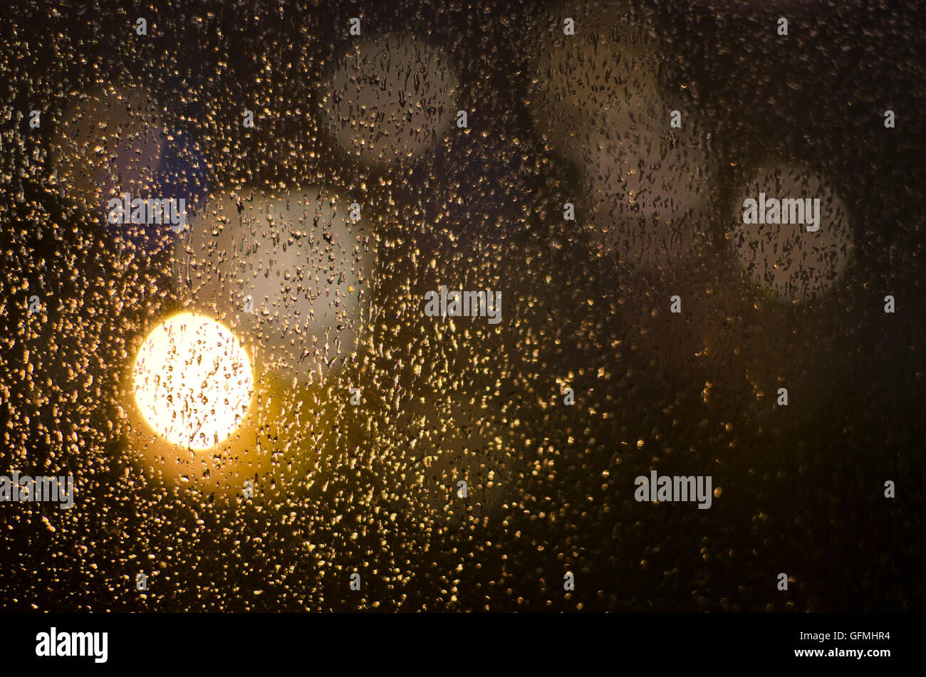 drops of rain on the window and colored bokeh Stock Photo - Alamy