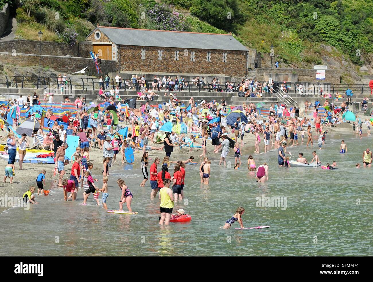 Looe beach, Cornwall, UK. Tourists enjoy the weather at Looe beach in