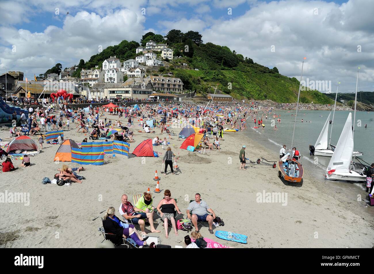 Looe beach, Cornwall, UK. Tourists enjoy the weather at Looe beach in