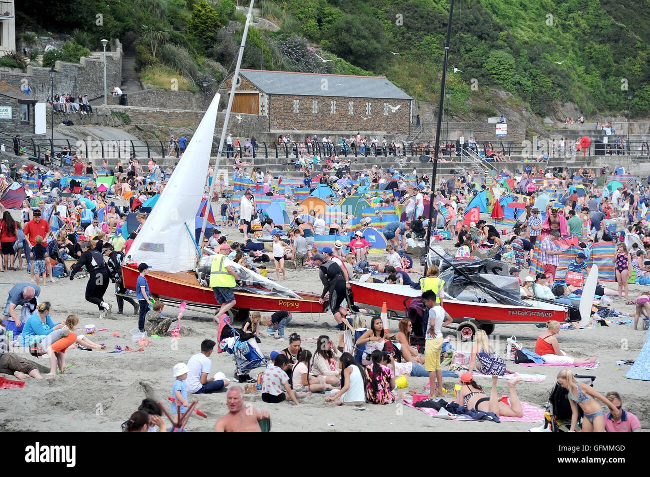 Looe beach, Cornwall, UK. Tourists enjoy the weather at Looe beach in