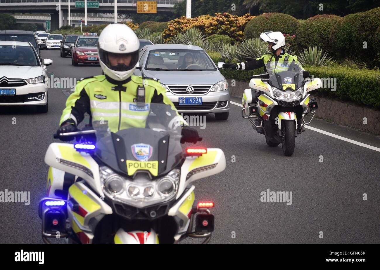 Shenzhen, China's Guangdong Province. 1st Aug, 2016. Traffic policemen patrol along a high-occupancy vehicle lane (HOV lane) in Shenzhen, south China's Guangdong Province, Aug. 1, 2016. Shenzhen's first HOV lane was put into use on Monday to increase average vehicle occupancy with the goal of reducing traffic congestion and air pollution. © Mao Siqian/Xinhua/Alamy Live News Stock Photo