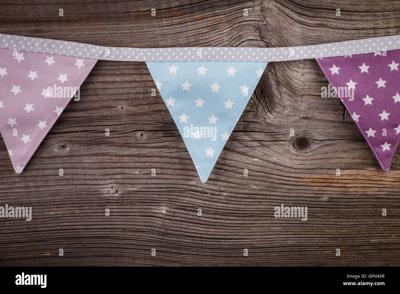 Party triangle bunting flags hanging on the rope. On the old