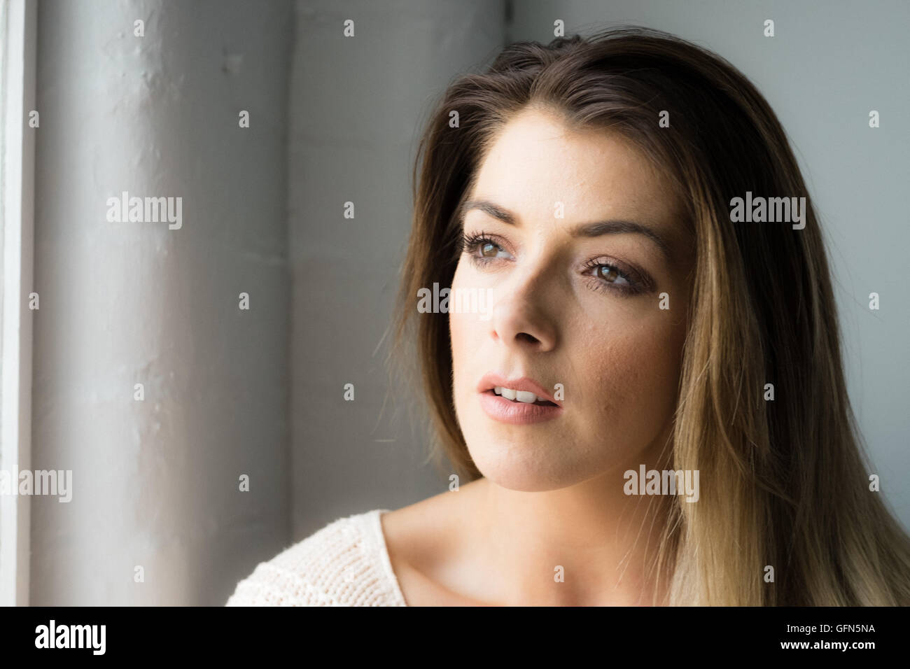 Thoughtful attractive womanin her 20s Stock Photo