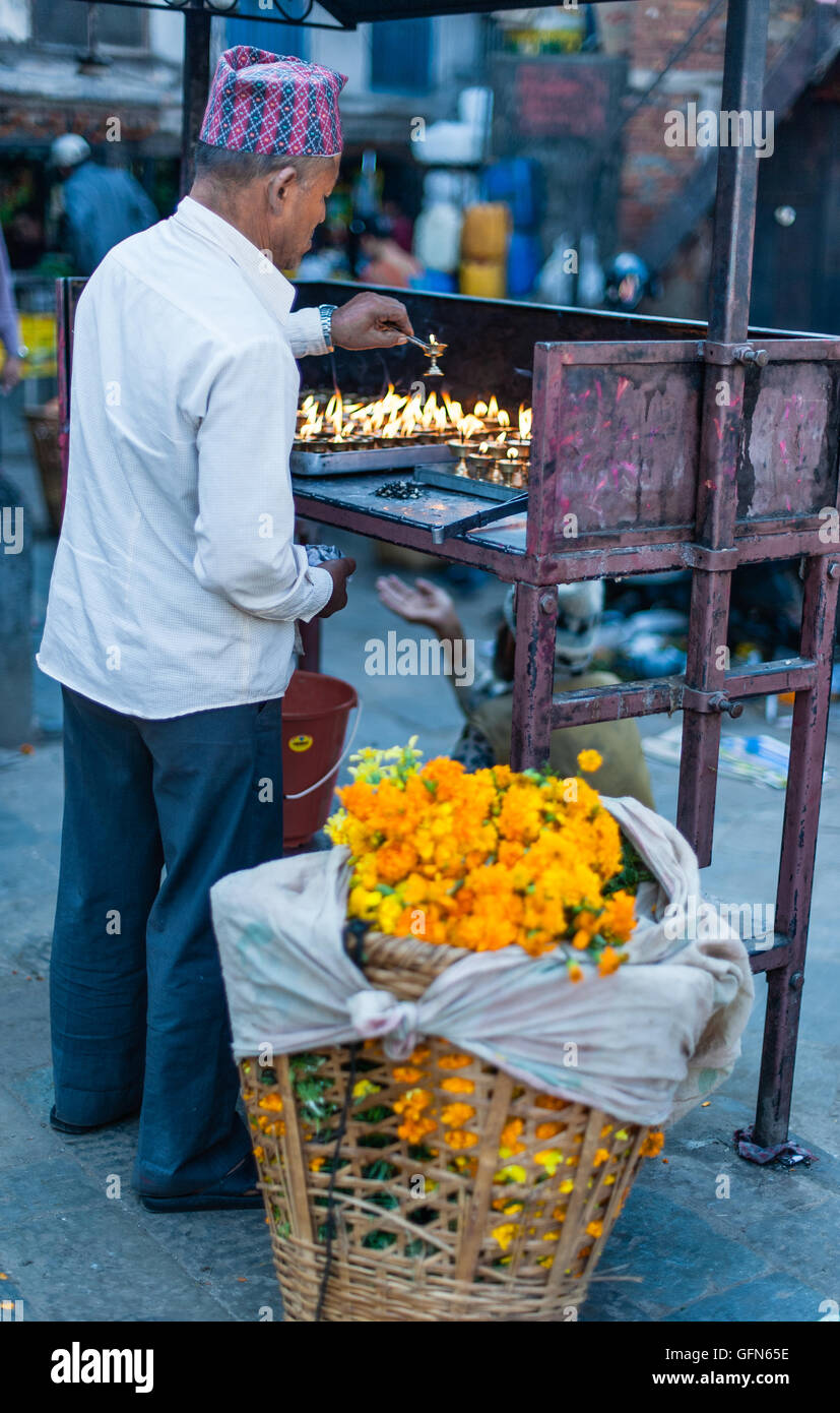Nepalese man lighting candles Stock Photo