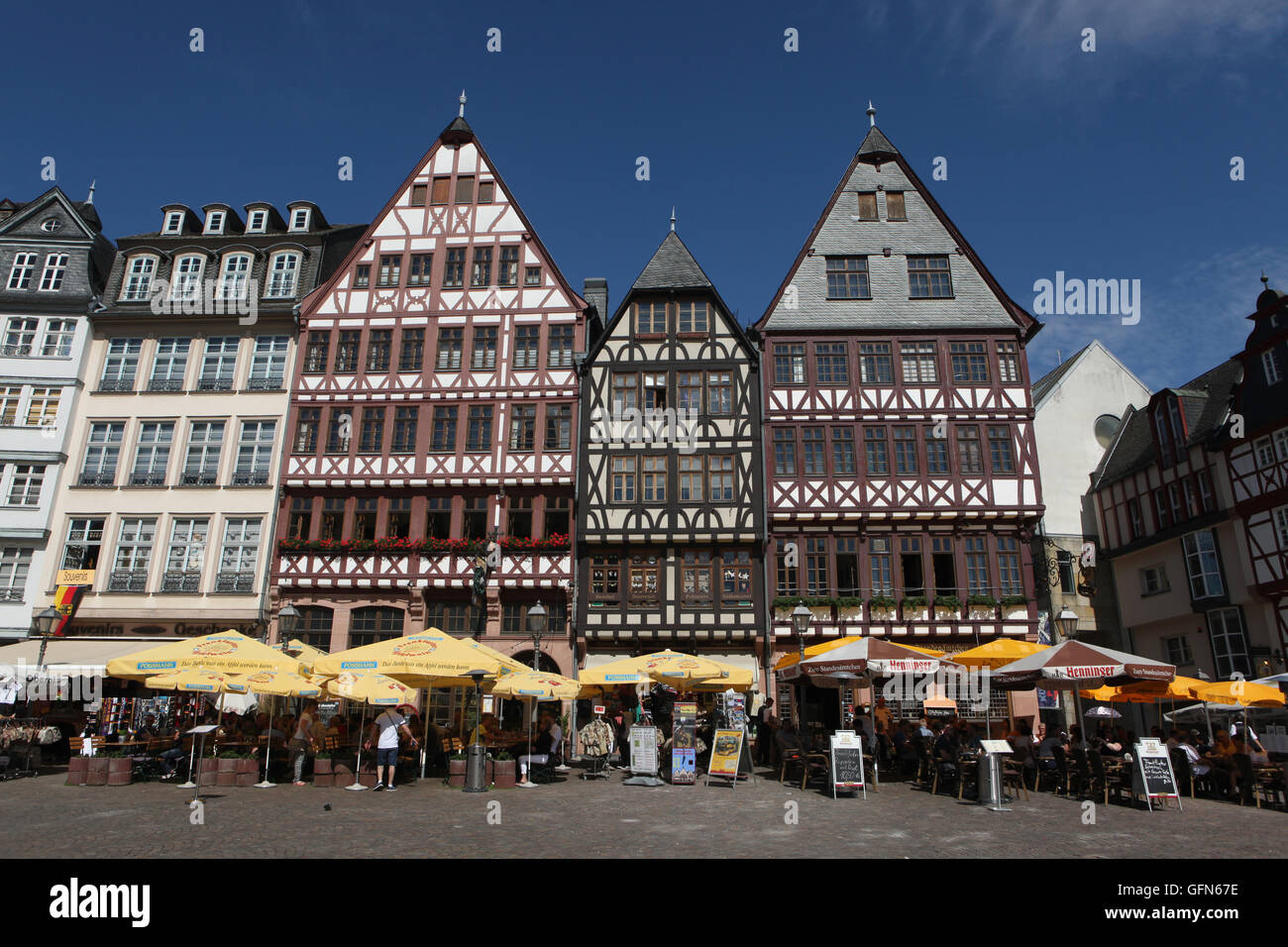Tourists in front of the reconstructed half-timbered houses of the Ostzeile at the Romerberg in Frankfurt am Main, Germany. Stock Photo