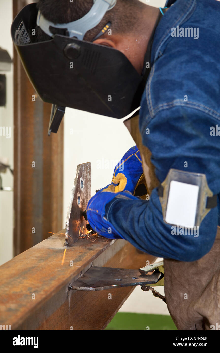 Welding a beam wearing protective clothes and equipment Stock Photo Alamy