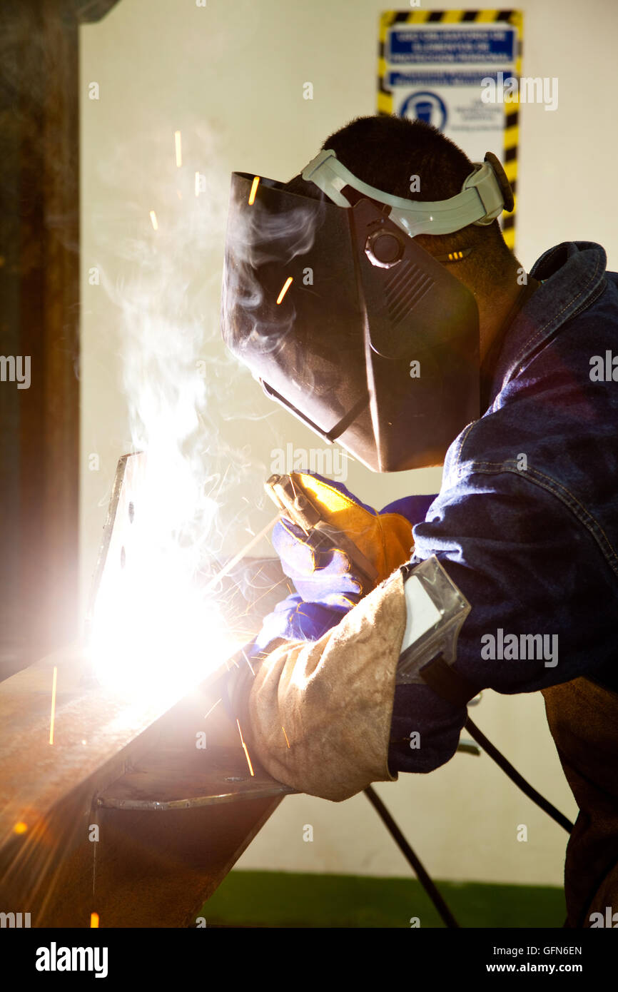 Welding a beam wearing protective clothes and equipment Stock Photo Alamy