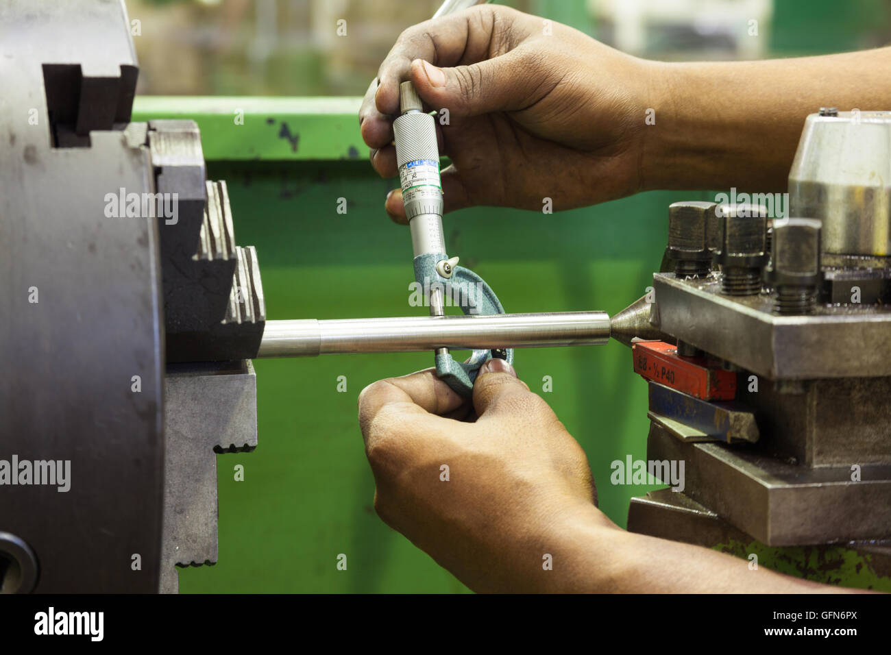 Man using a micrometer to measure a rod diameter Stock Photo Alamy